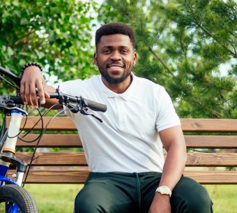 ecology and transportation concept. modern young Afro American businessman cycling to work on bicycle.